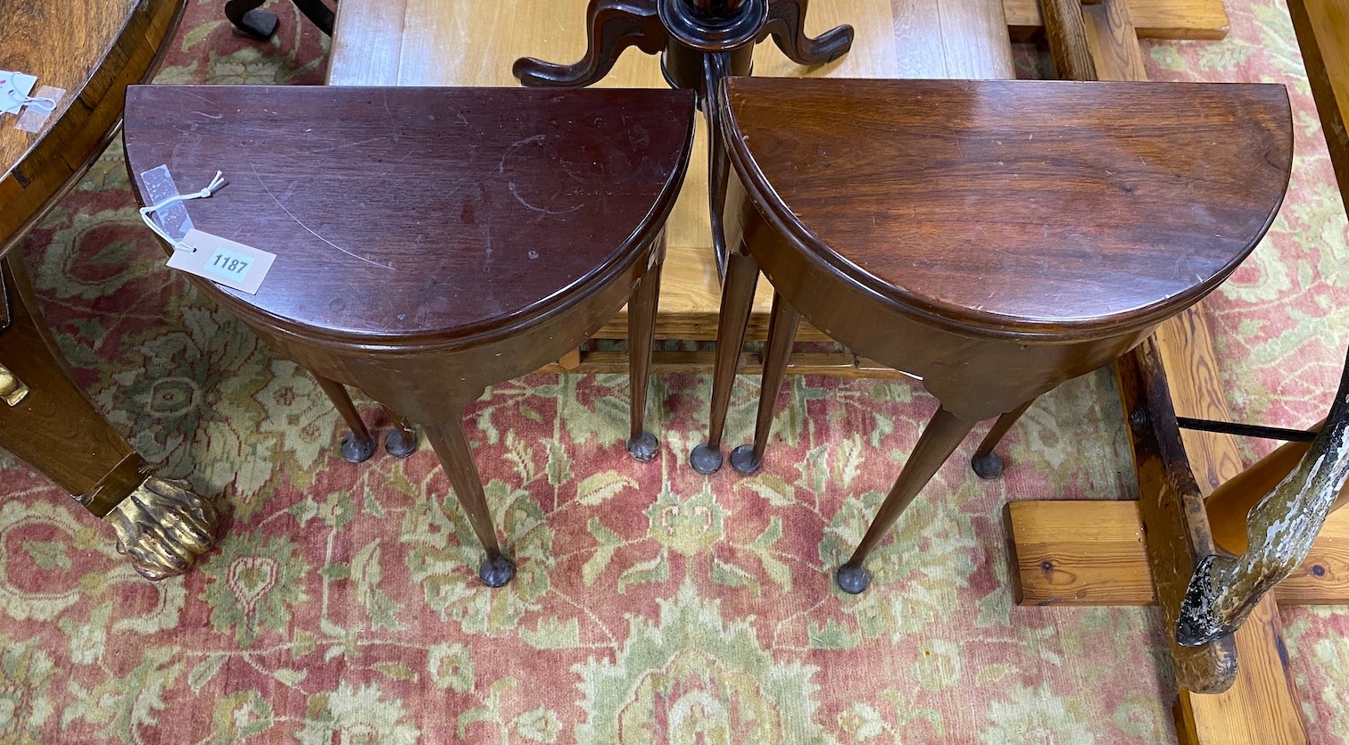 A near pair of small George II style red walnut D shaped folding tea tables, width 45cm, depth 22cm, height 74cm